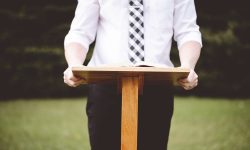 a-closeup-shot-of-a-male-in-front-of-a-speech-stan-2026-01-11-10-11-09-utc