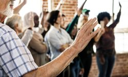 People raising their hands in a seminar