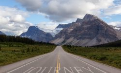 Scenic road in the Canadian Rockies during a vibrant sunny summer day. Taken in Icefields Parkway, Banff National Park, Alberta, Canada.